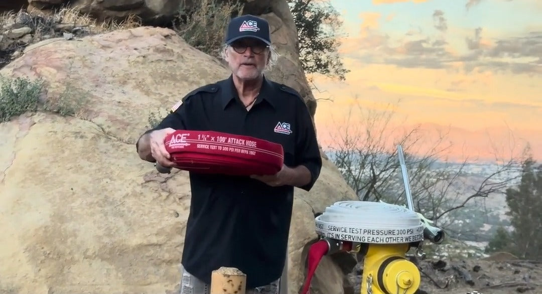Sherwin Ross holding the Ace Fire Defense Big Red 1¾" x 100' attack hose next to a fire hydrant