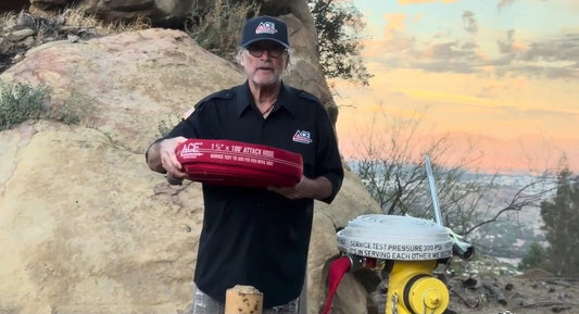Sherwin Ross holding the Ace Fire Defense Big Red 1¾" x 100' attack hose next to a fire hydrant