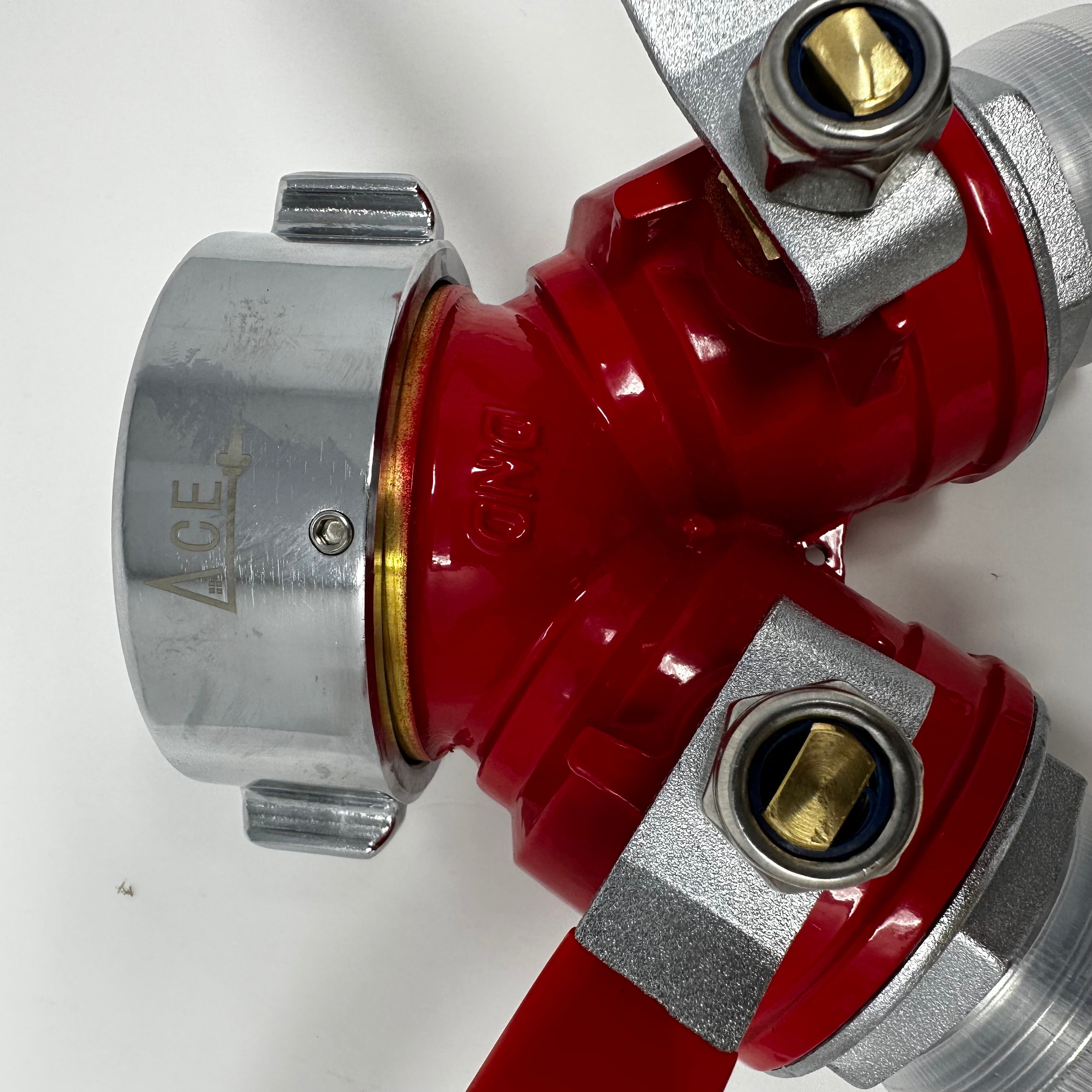 Close-up view of a red and silver brass-gated WYE valve with a lever handle, designed for fire hydrants.