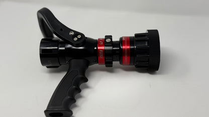 A professional pistol grip 1.5” NH nozzle with black and red coloration, featuring a hose connection and a control handle.