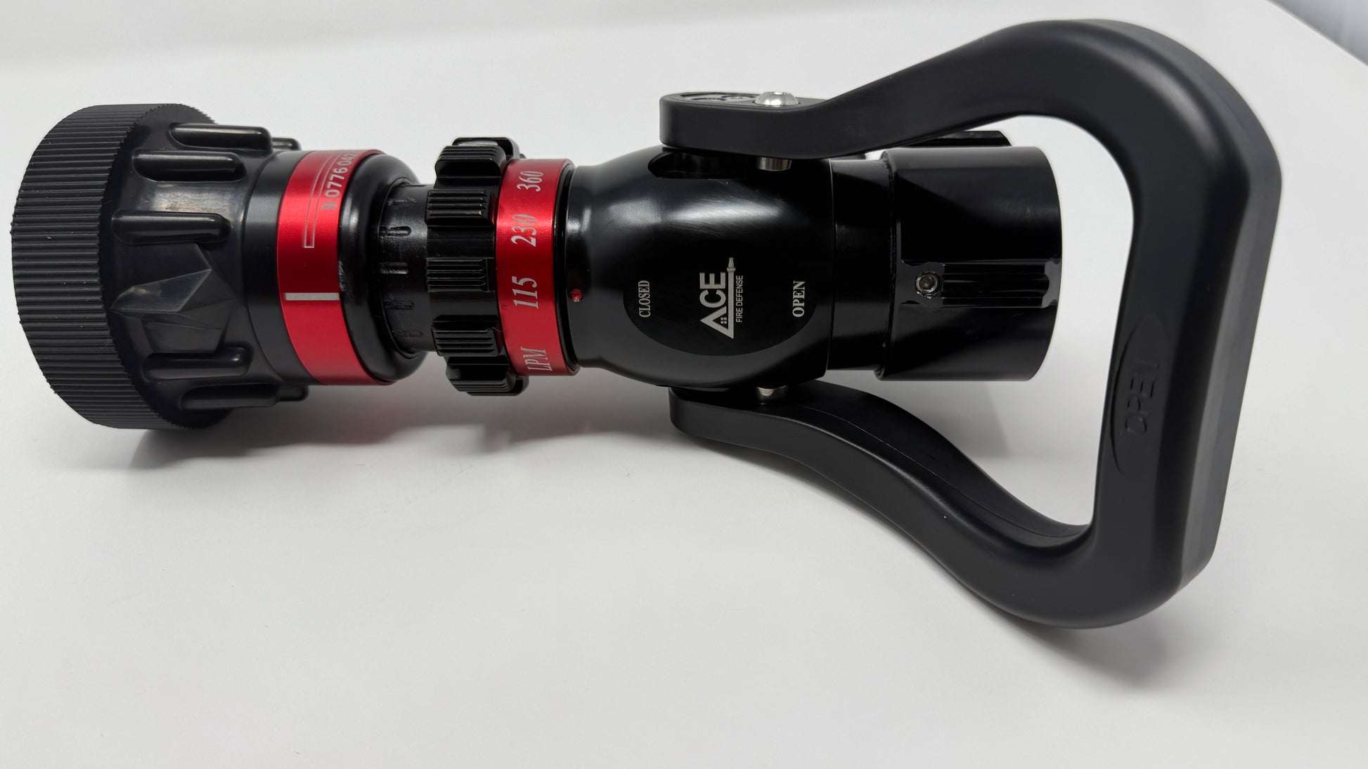 A professional pistol grip 1.5” NH nozzle with black, red, and silver colors, designed for fire fighting operations.